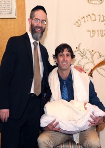 Rabbi Hamaoui with a family following a Brit Mila