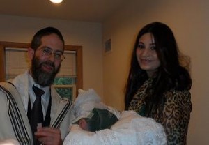 Rabbi Hamaoui with a family and their newborn